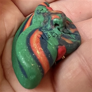 Sculpty clay studio button of a hat by Maria Kragh.