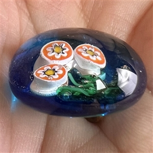 Glass paperweight studio button of flowers.
