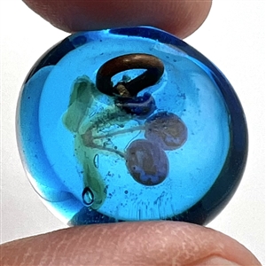 Glass paperweight studio button of flowers.