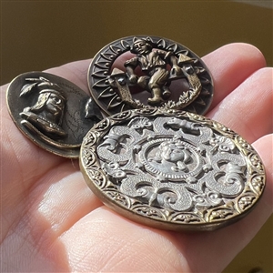 Three brass people buttons including a Kate Greenaway.