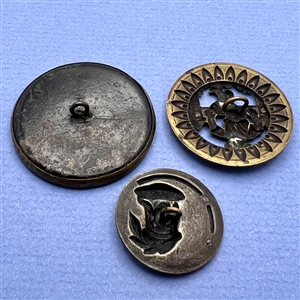 Three brass people buttons including a Kate Greenaway.