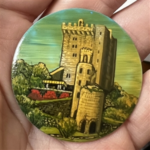Castle painted on shell studio button signed “Shaw.”
