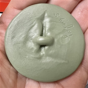 Jasperware studio button of robed child and deer by Shirley Shaw.