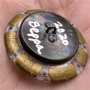 Studio button of a frog.