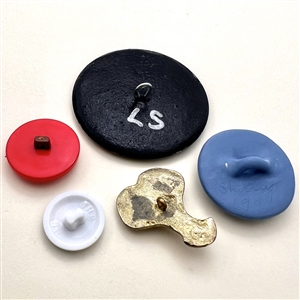 Five assorted buttons of cartoon characters etc.