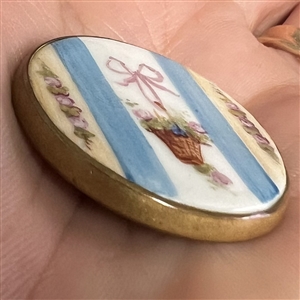 A 19th c. Painted porcelain button of bow  and basket of flowers.