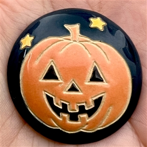 Ceramic Halloween pumpkin button by Golem Design Studio.