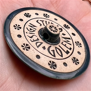 Ceramic Halloween pumpkin button by Golem Design Studio.