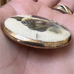 Studio ceramic button of a Siamese cat by Stella Rzanski. 