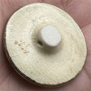 Studio ceramic button of a Siamese cat by Stella Rzanski. 