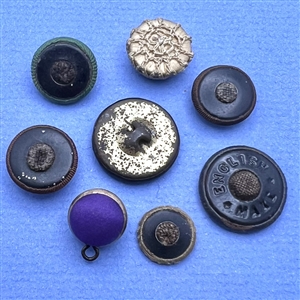Eight assorted fabric buttons.