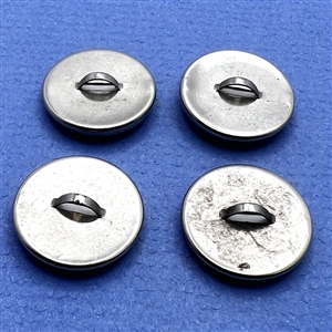 Set of four paper under celluloid sheet (?) set in metal buttons.