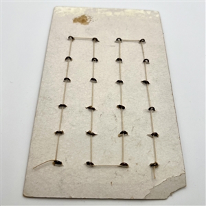 Original store card of 24 brass fish buttons by La Mode.