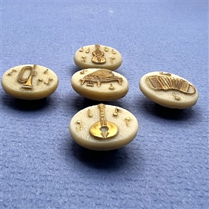 Set of five caramel glass buttons of musical instruments.