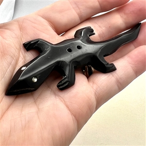 Carved horn (?) button of a salamander. 