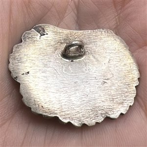 White metal button of a realistic scallop shell.