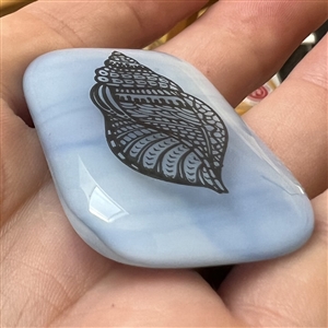 Fused glass studio button with transfer of a shell by Mona Ledwin.