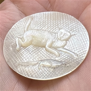 Bethlehem pearl button of “a cat chasing a rat.”