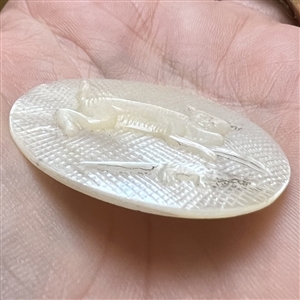 Bethlehem pearl button of “a cat chasing a rat.”