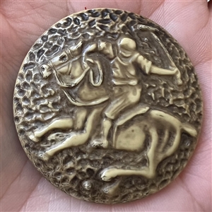 Vintage celluloid button of polo player on a horse.