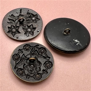 Three Victorian brass buttons of flowers.