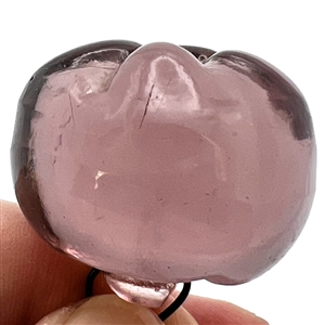 Sculptural transparent purple glass button of a pepper. 