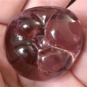 Sculptural transparent purple glass button of a pepper. 