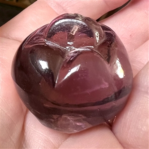 Sculptural transparent purple glass button of a pepper. 