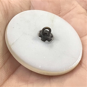 White glass and black glass button with a rosette shank of Sissieretta Jones.