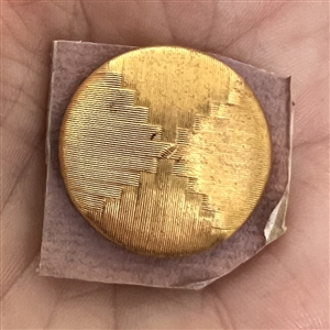 An 18th c. woven gold metal cap button of death's head design.