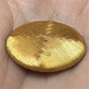 An 18th c. woven gold metal cap button of death's head design.