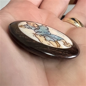 Natural material in boxwood button of an Asian boy playing with a cat.