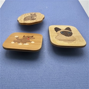 Three marquetry wood studio buttons of cats by Everett Hartman.