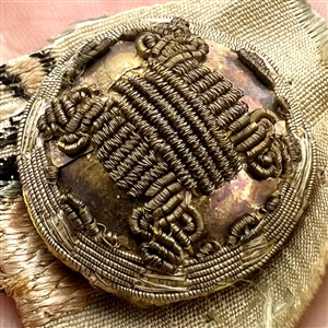 An 18th c. Passementerie button with gold bullion on original fabric.