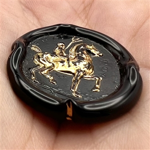 Bimini black glass button of a man on horseback. 