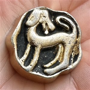 French aluminum button of a dog.