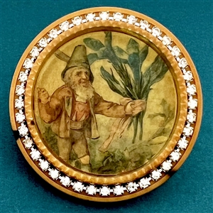 Bob Benson studio button of a gnome holding iris’s.