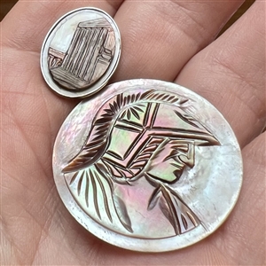 Two cameo carved pearl buttons.