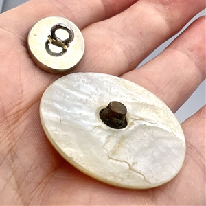 Two cameo carved pearl buttons.