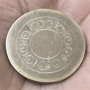 An 18th c. Tombac button with center designs.