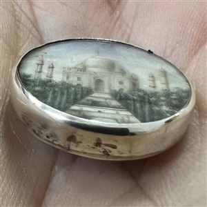 Painting on natural button of the Taj Mahal.