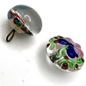 Two glass and paperweight studio buttons.