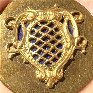 Brass button of a royal shield.