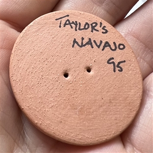 Navajo ceramic pottery button of a scene.