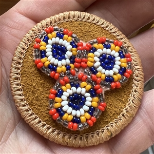 Native American beaded leather button.
