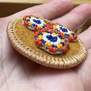 Native American beaded leather button.