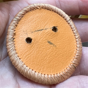 Native American beaded leather button.