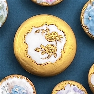 Ten painted porcelain studs of flowers.