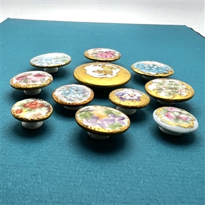 Ten painted porcelain studs of flowers.