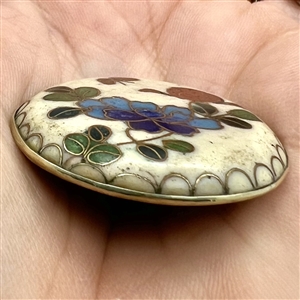 Cloisonné enamel button of flowers.